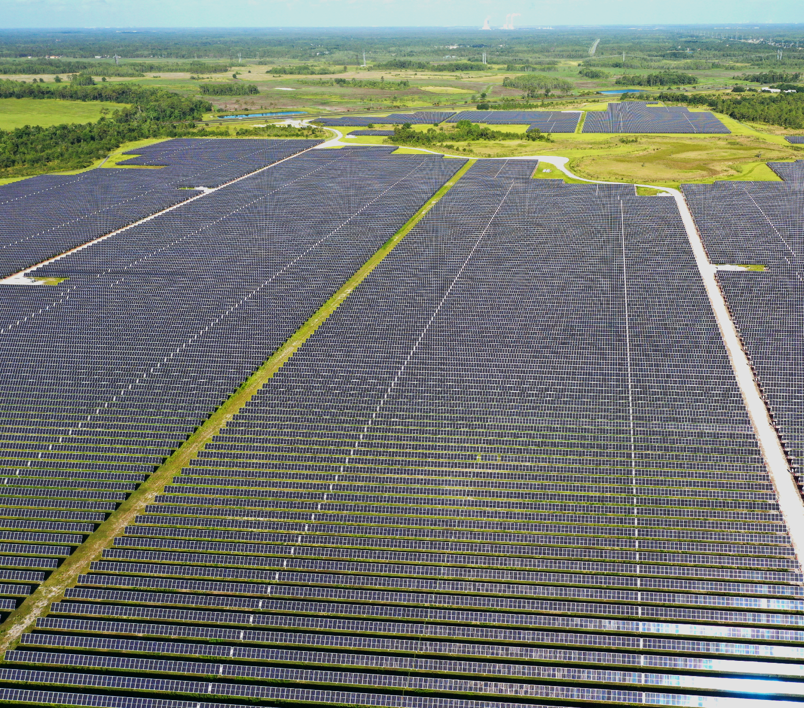 Arial view of solar panels in a green field