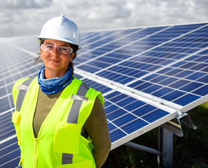 FPL employee in front of the solar panels